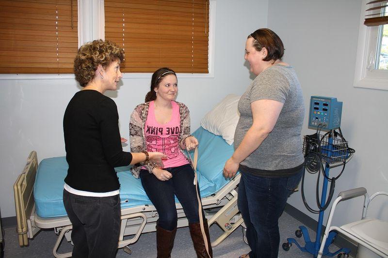 Students complete self-care training lab exercises in the OT House lab space.